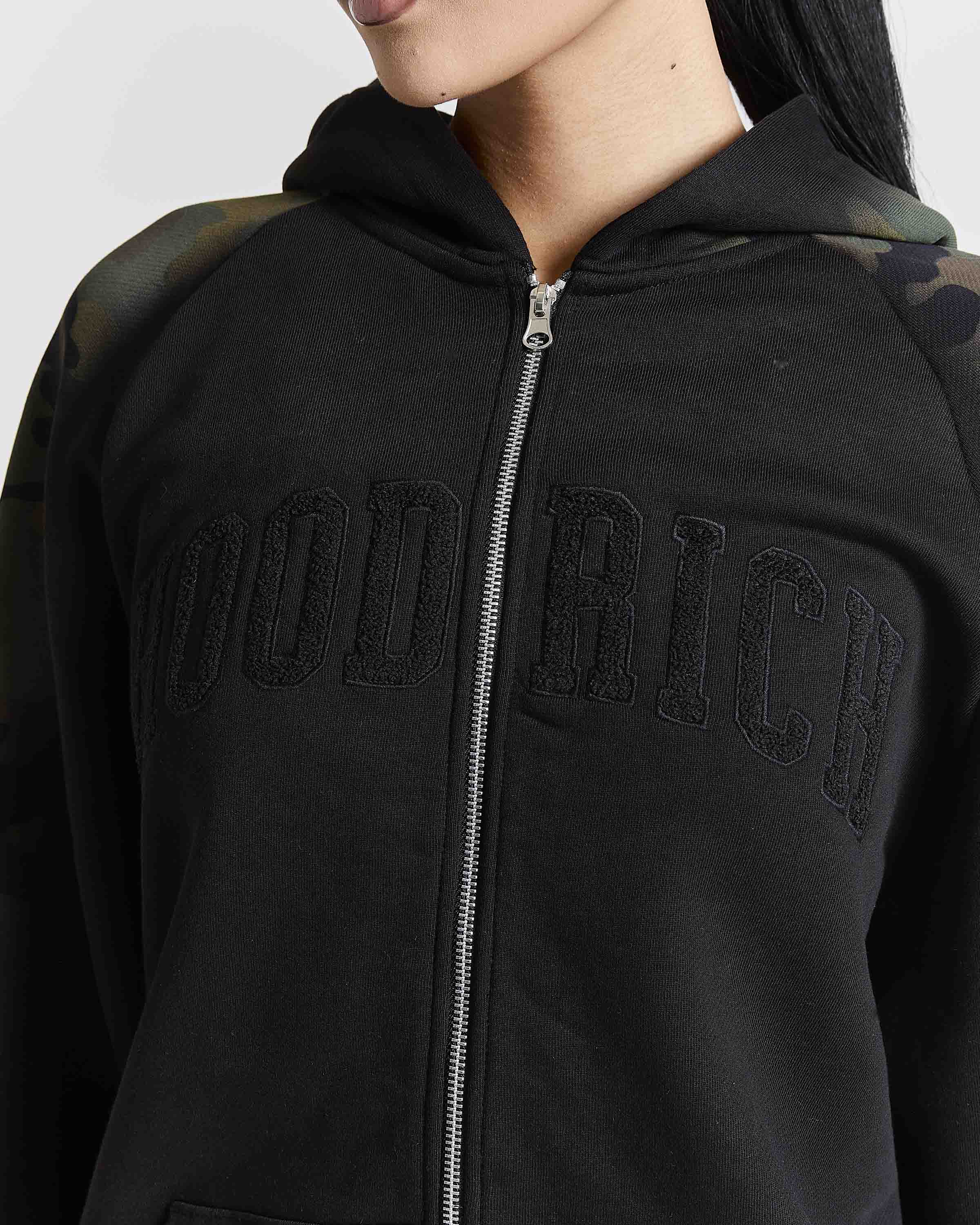 Displays a model wearing the Black camo 'Hoodrich' branded women's Shade Matching Shorts Set