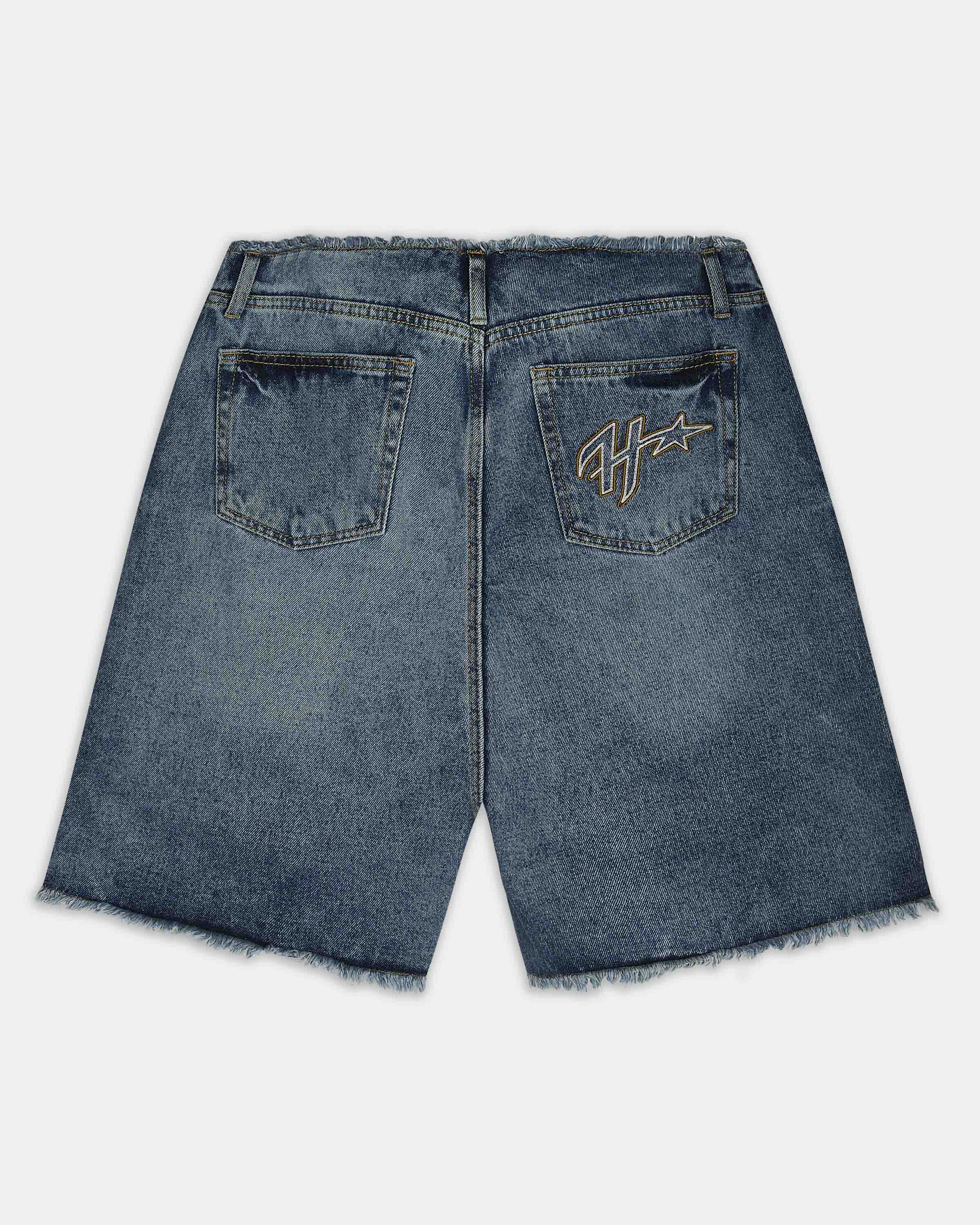 Back view of blue denim shorts with a raw frayed hem, featuring a gold embroidered logo on the right pocket.