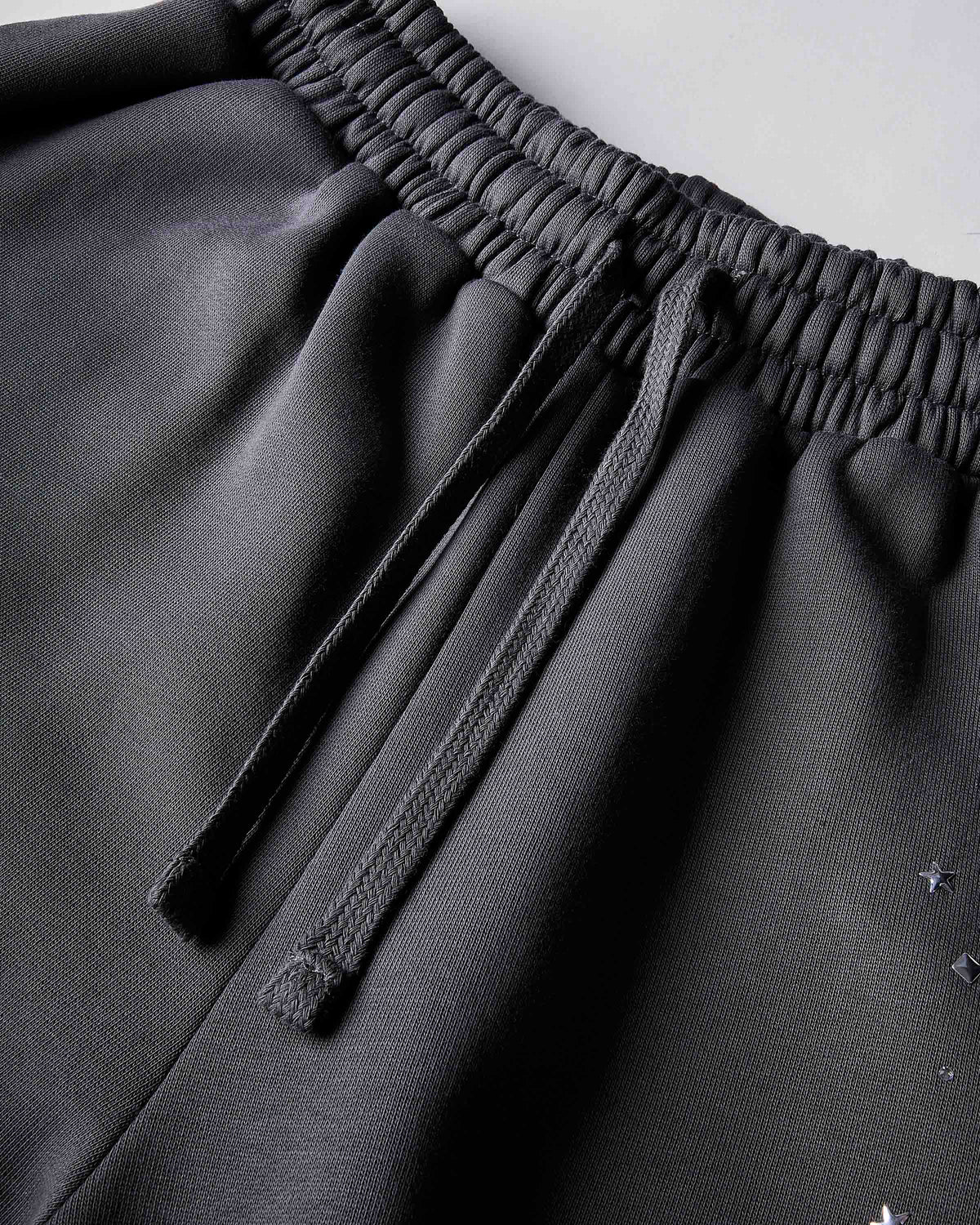 Displays the silver 'hoodrich' branded Clash V2 Oversized Wide Leg Joggers featuring the details on the straw stings
