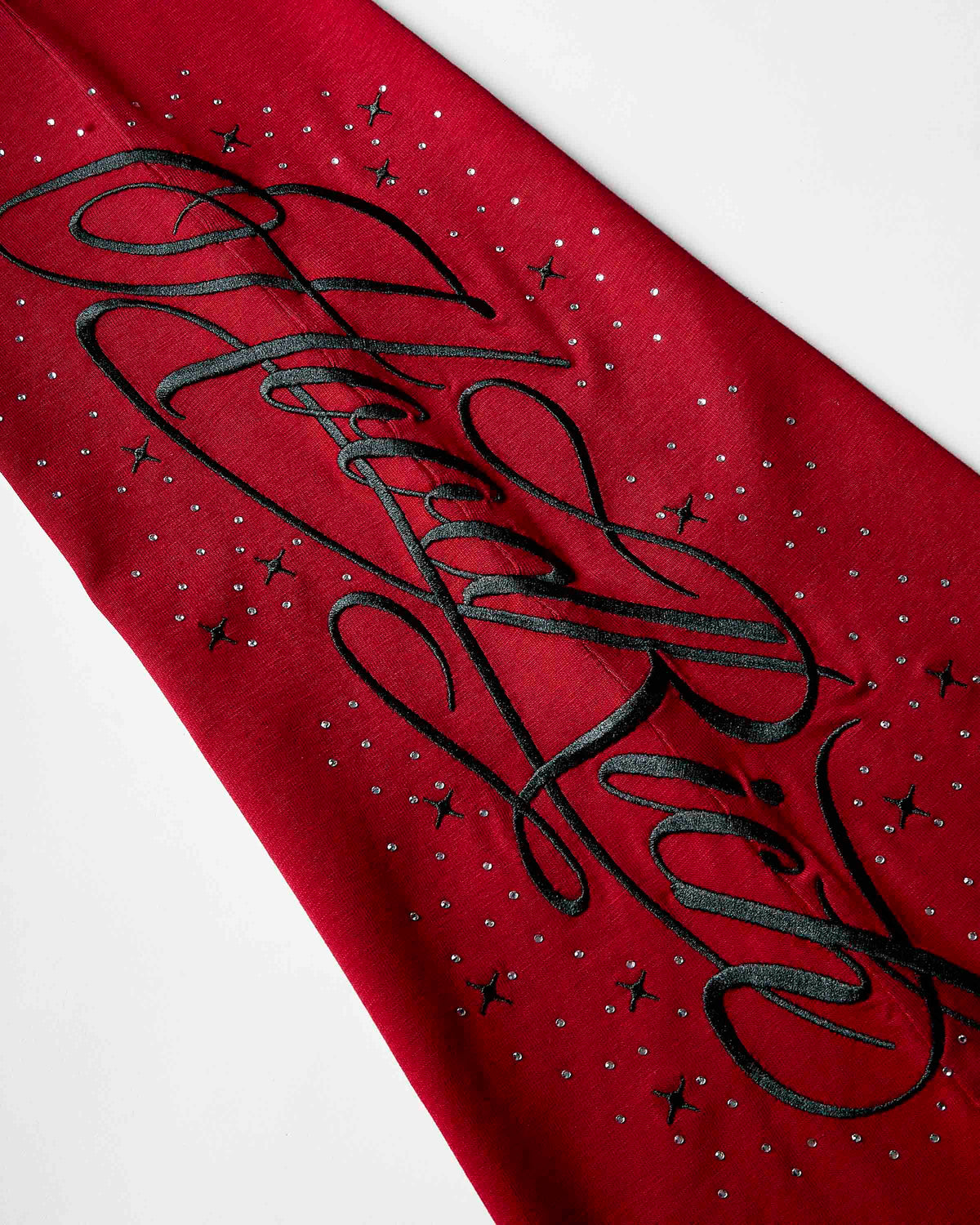 Displays the red 'hoodrich' branded Gleam Flare Legging featuring the hoodrich branding details