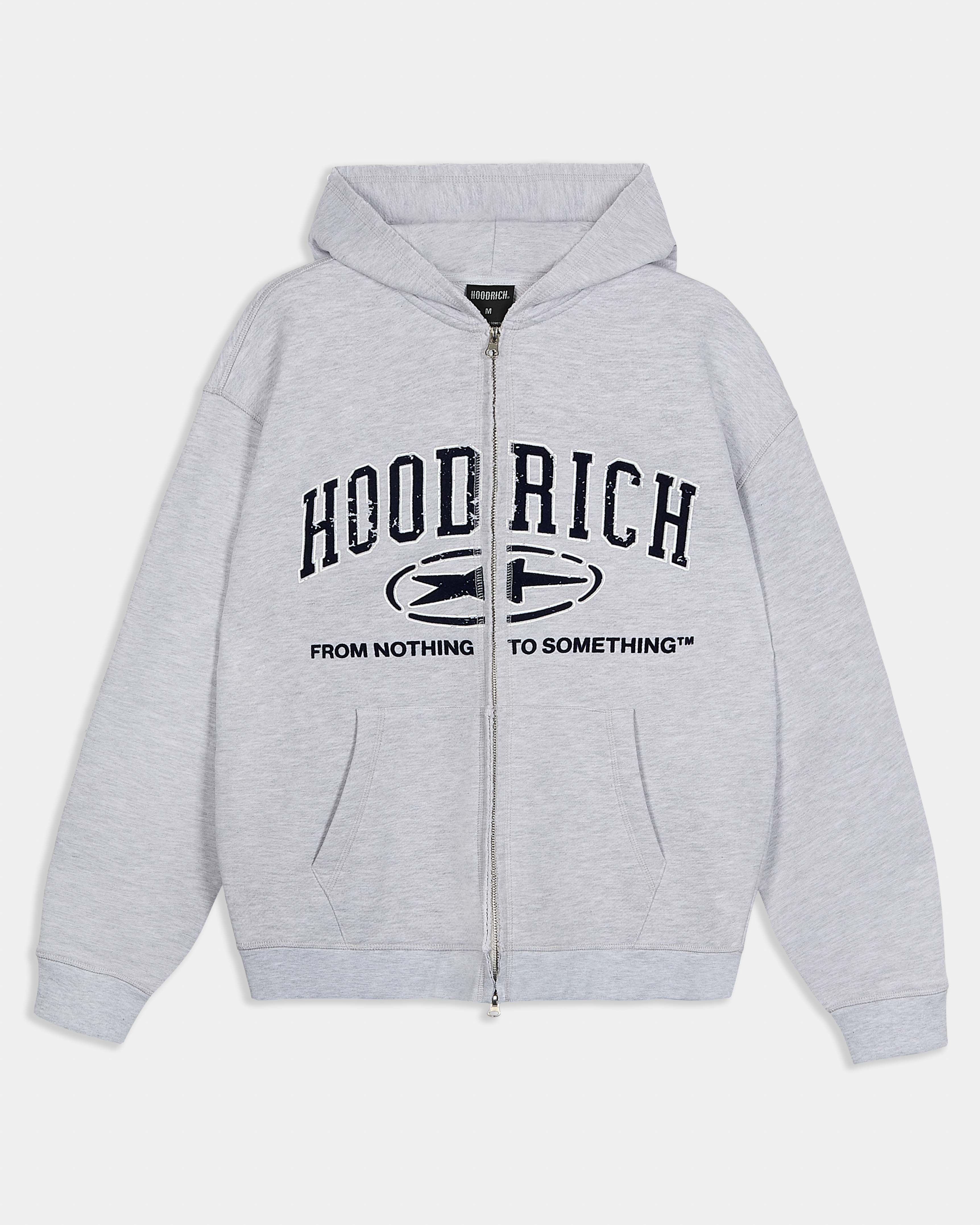 Relaxed grey marl zip-up hoodie featuring dark blue varsity-style Hoodrich branding and the slogan 'From Nothing To Something'