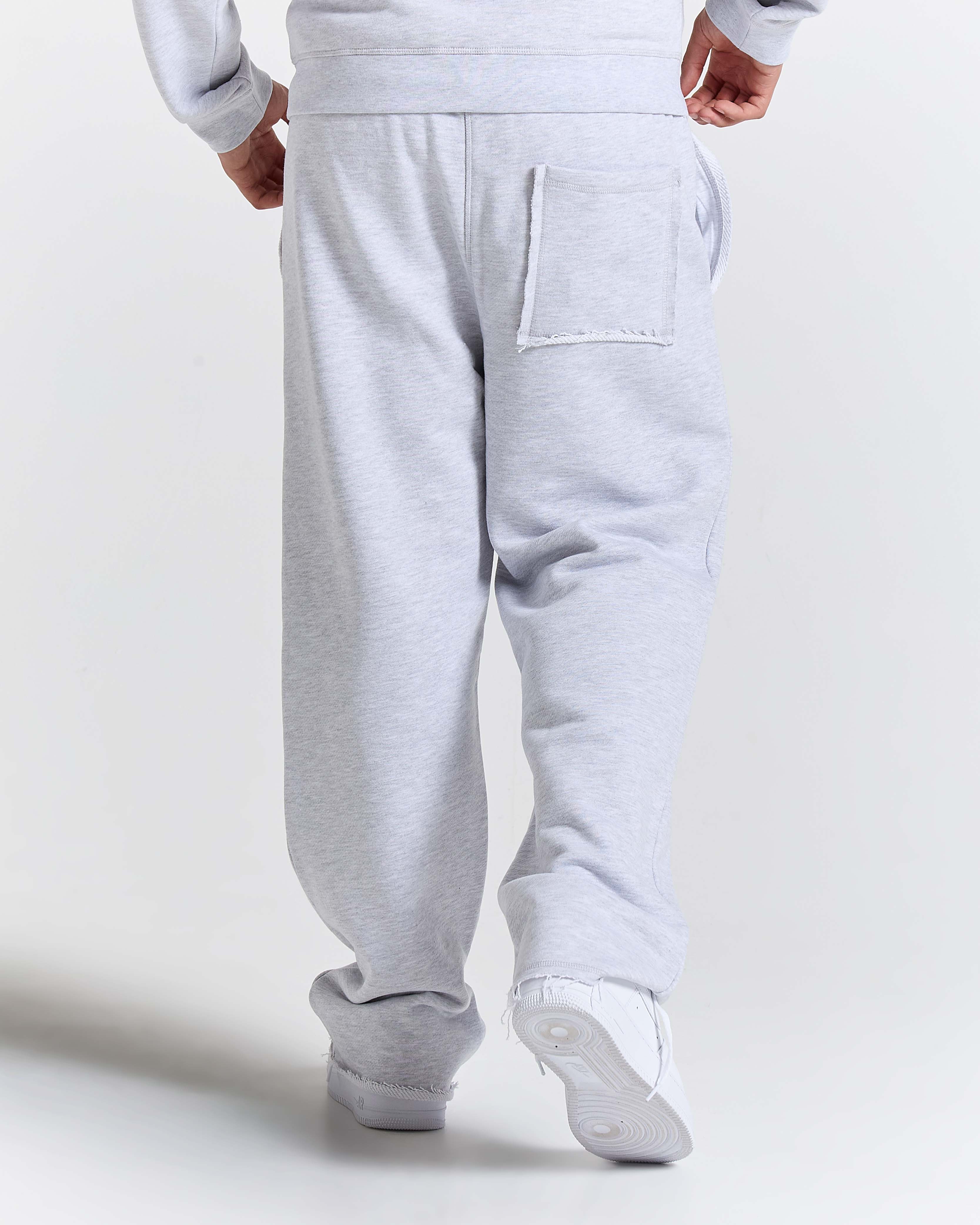 Person wearing gray sweatpants on a white background