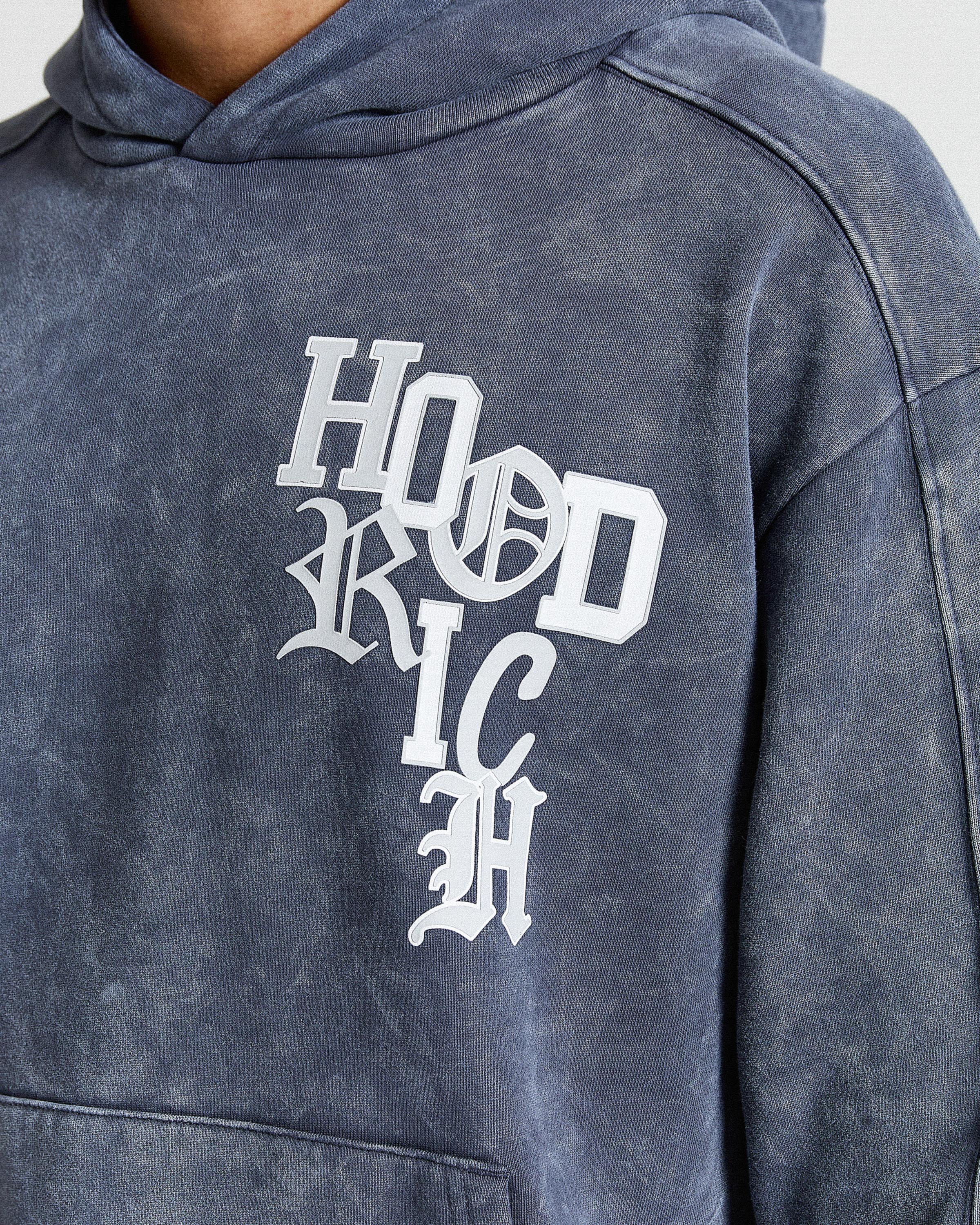 Displays a model wearing the Blue & white 'Hoodrich' branded Heritage Full Tracksuit