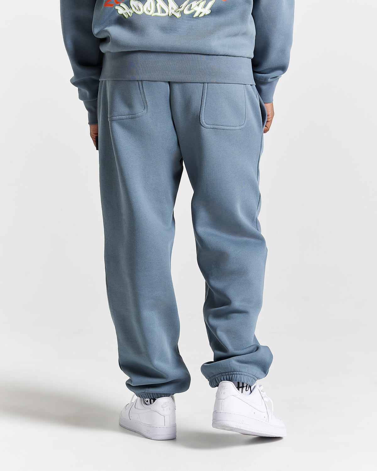 Displays a model wearing the Grey 'Hoodrich' branded men's Graff Rave Full Tracksuit