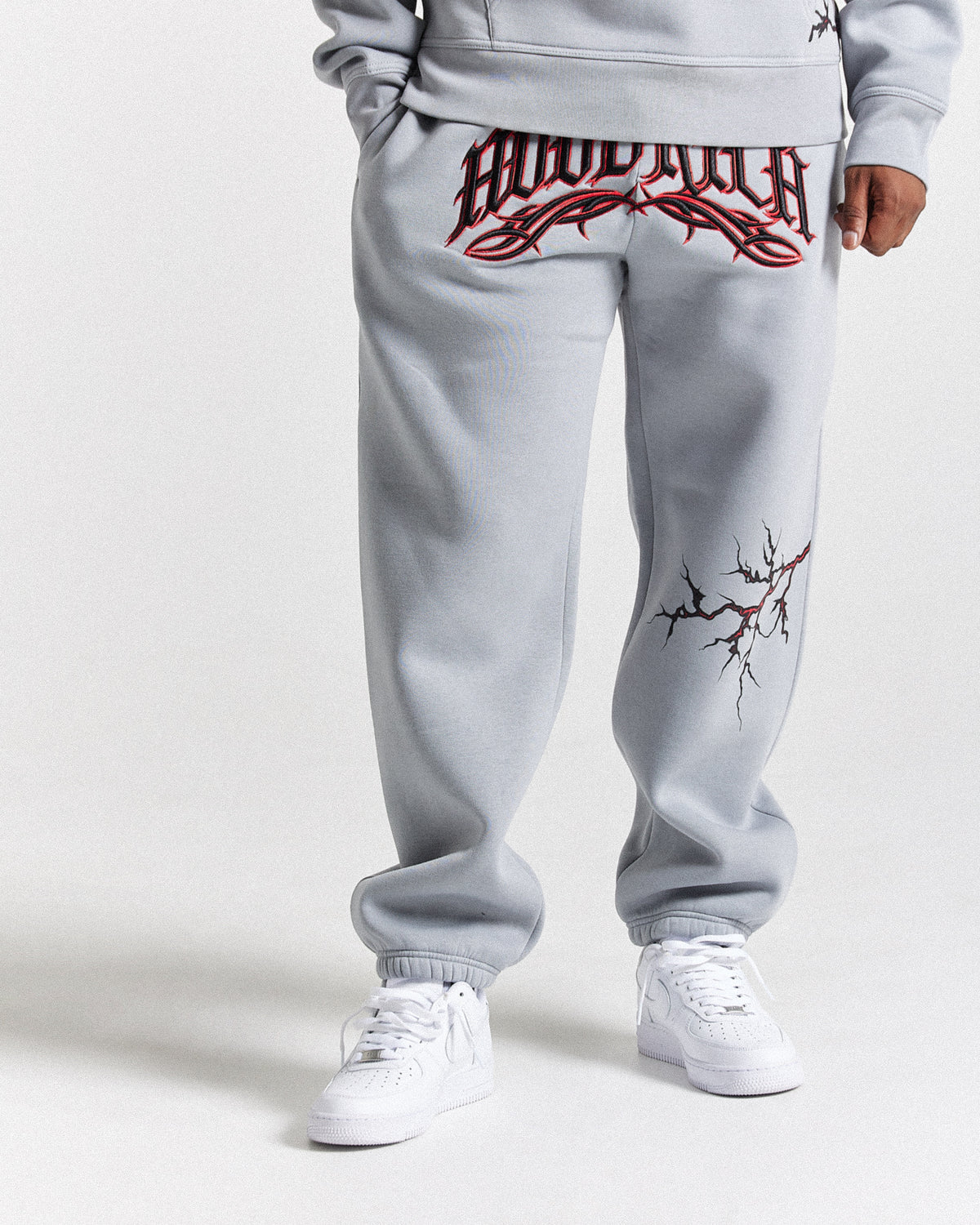 Displays a model wearing the Grey 'Hoodrich' branded men's Dark Full Tracksuit