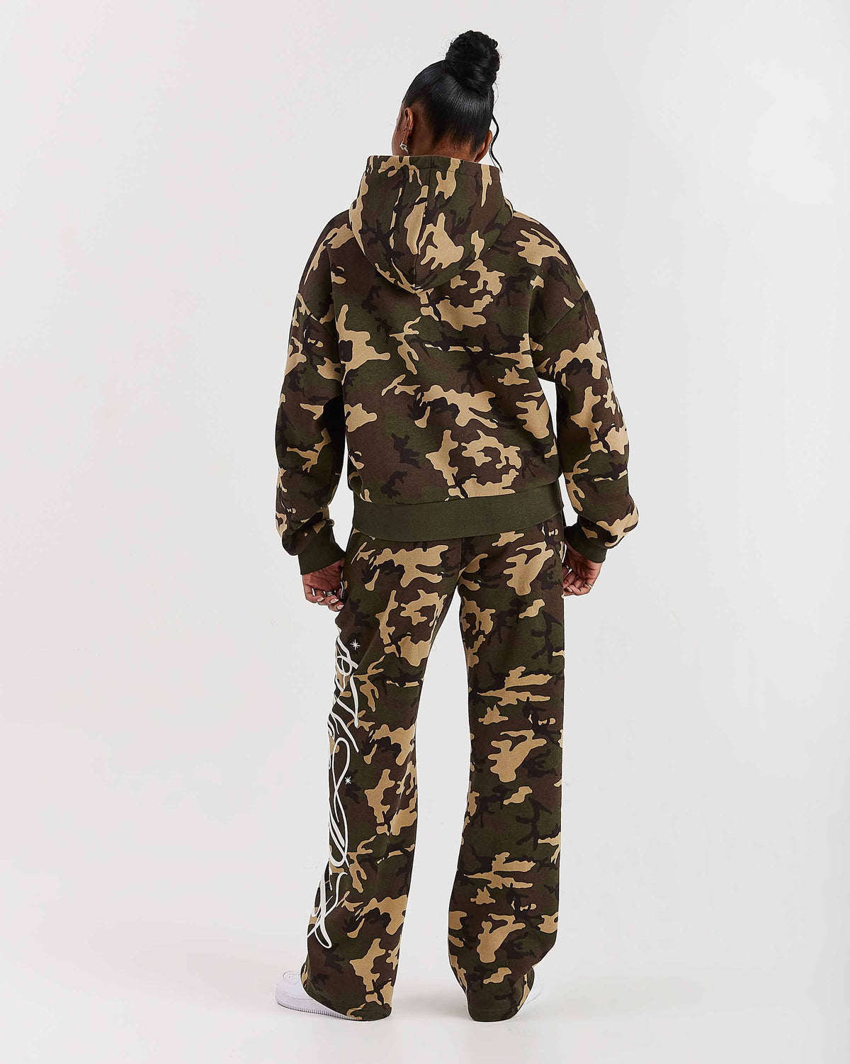 Displays a model wearing the Camo 'Hoodrich' branded women's Solace Full Tracksuit