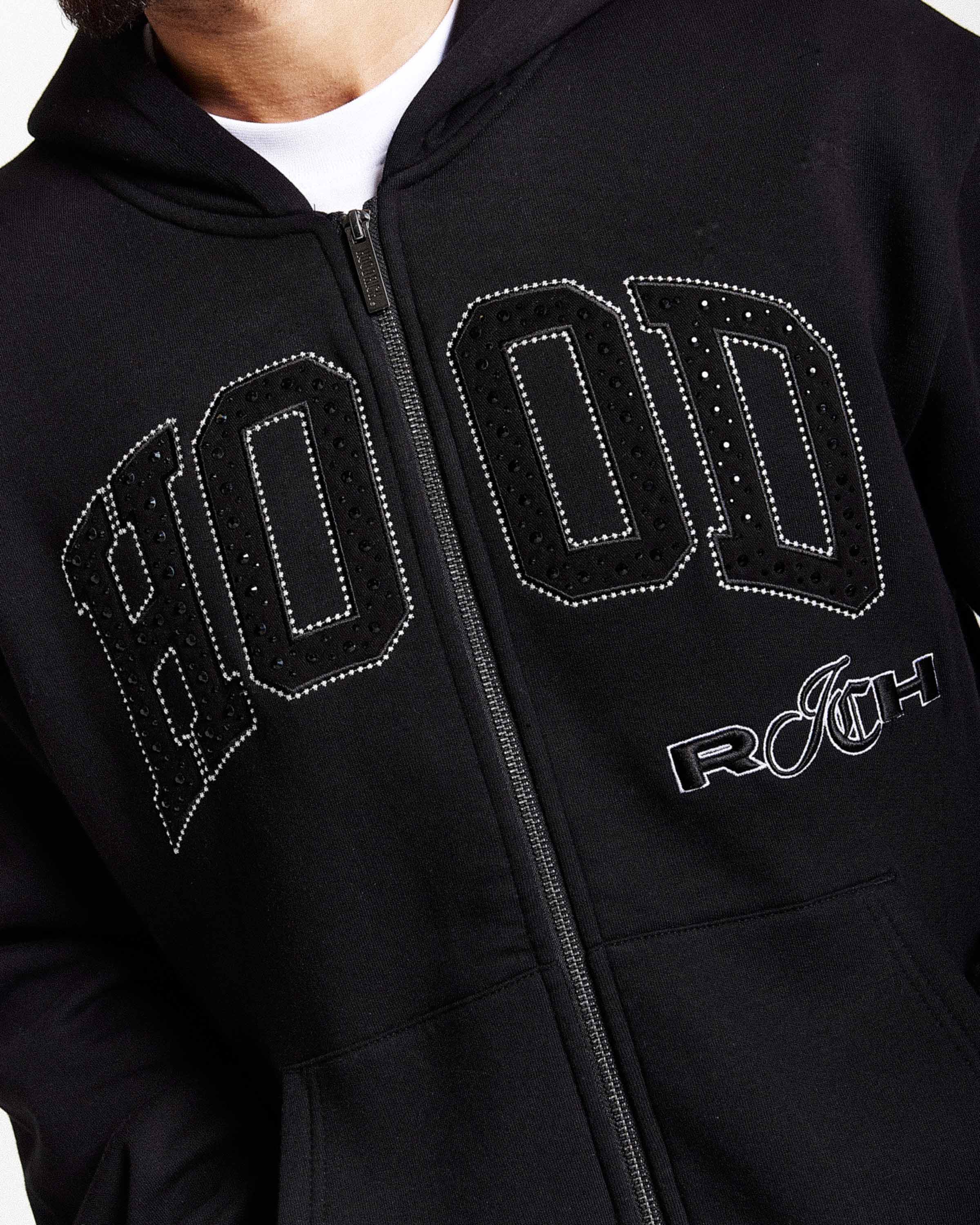 Black hoodie with 'HOODRICH' text design on a person wearing it.