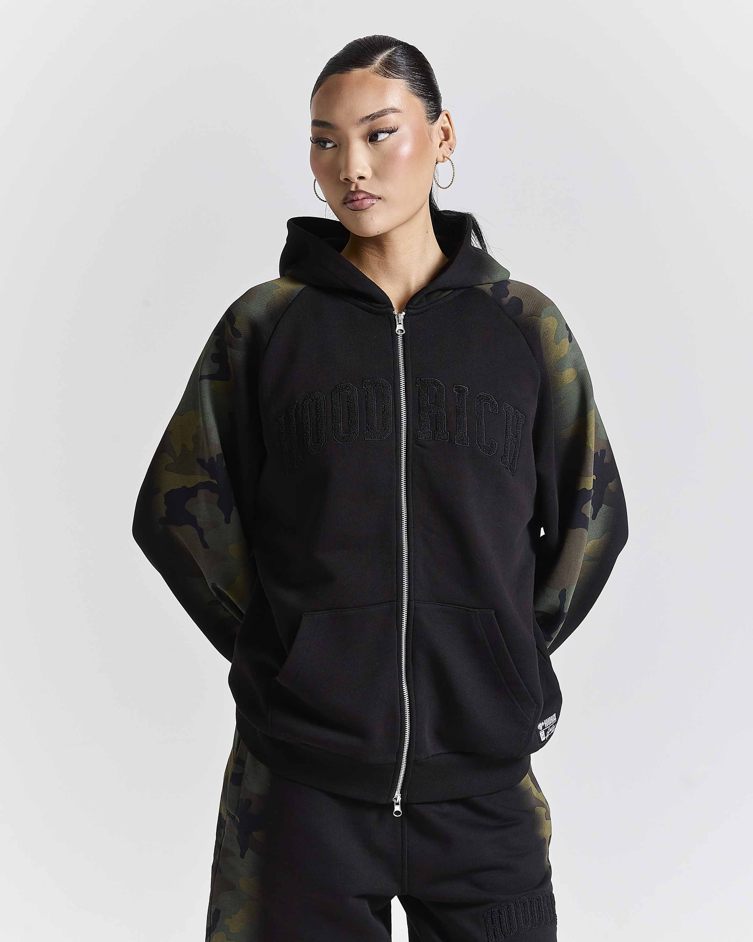 Displays a model wearing the Black camo 'Hoodrich' branded women's Shade Matching Shorts Set