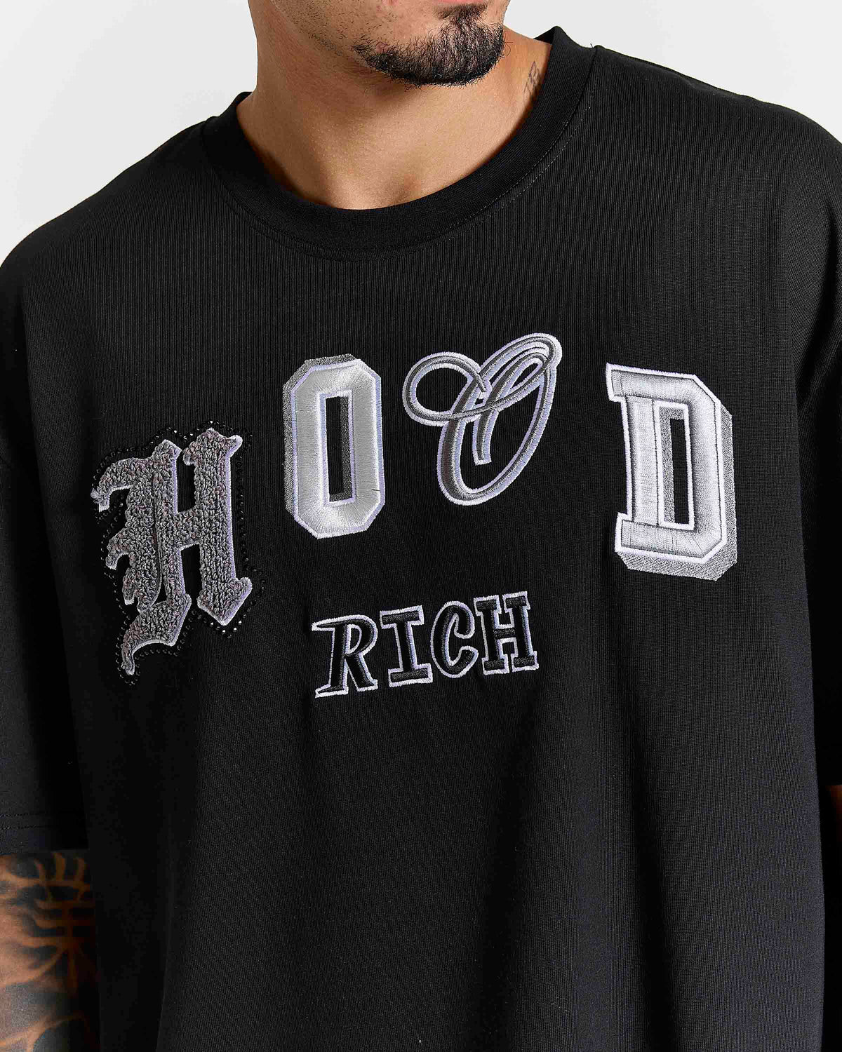 Displays a model wearing the Black lava smoke 'Hoodrich' branded Forza Oversized T-shirt featuring the hoodrich branding details