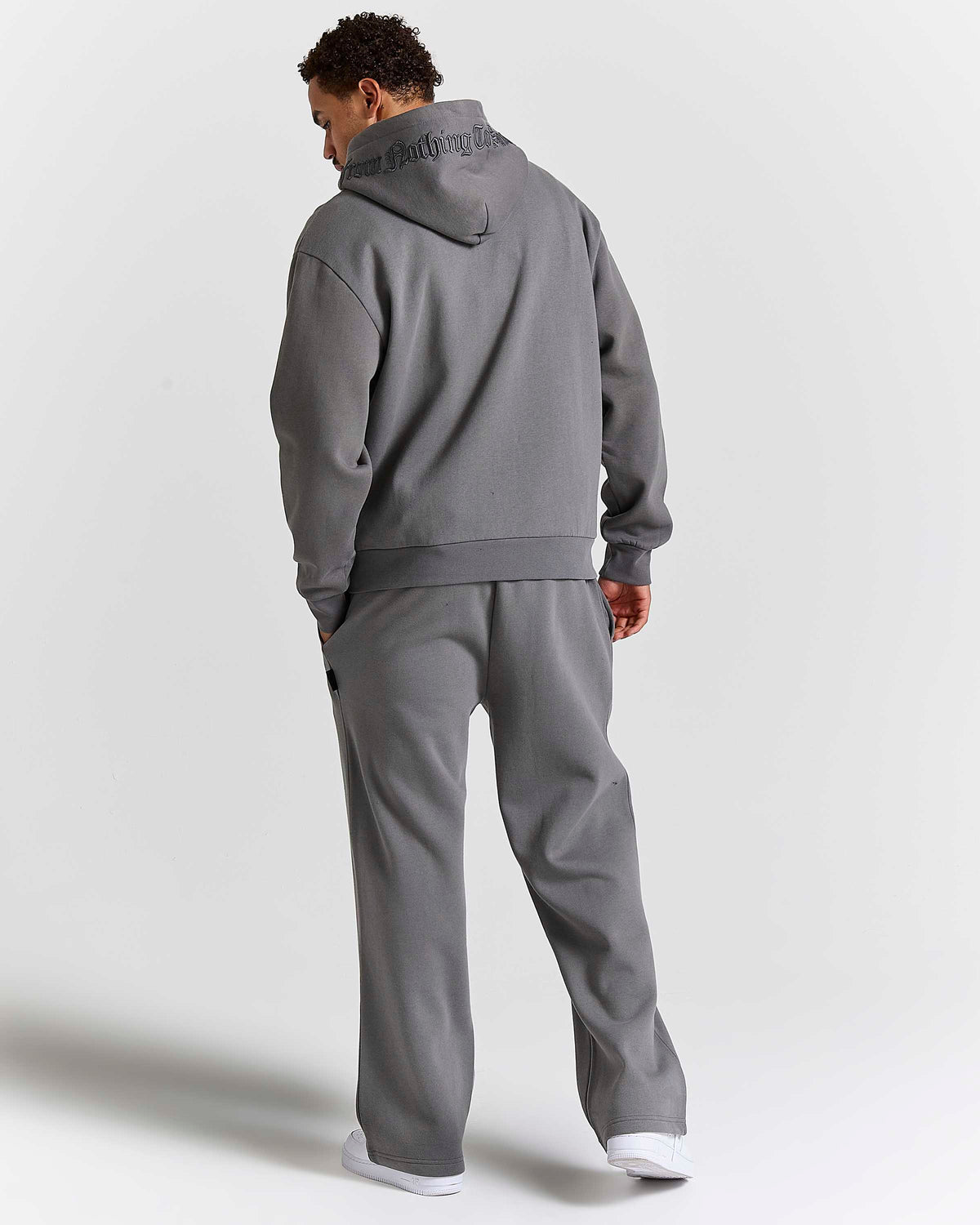 Displays a model wearing the Grey 'Hoodrich' branded men's Forza Full Tracksuit 