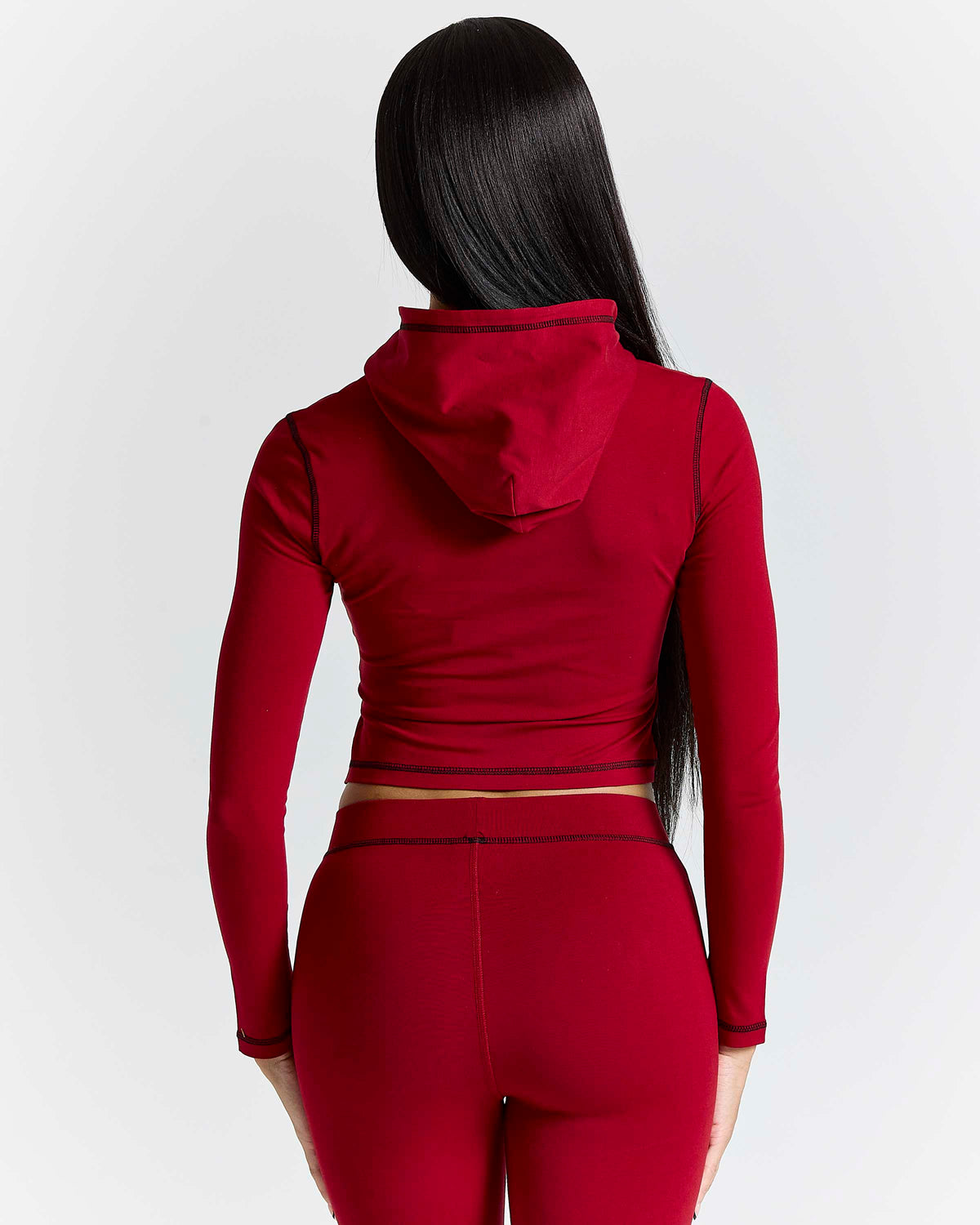 Displays a model wearing the red 'hoodrich' branded Gleam V2 Fitted Z/T Hoodie 