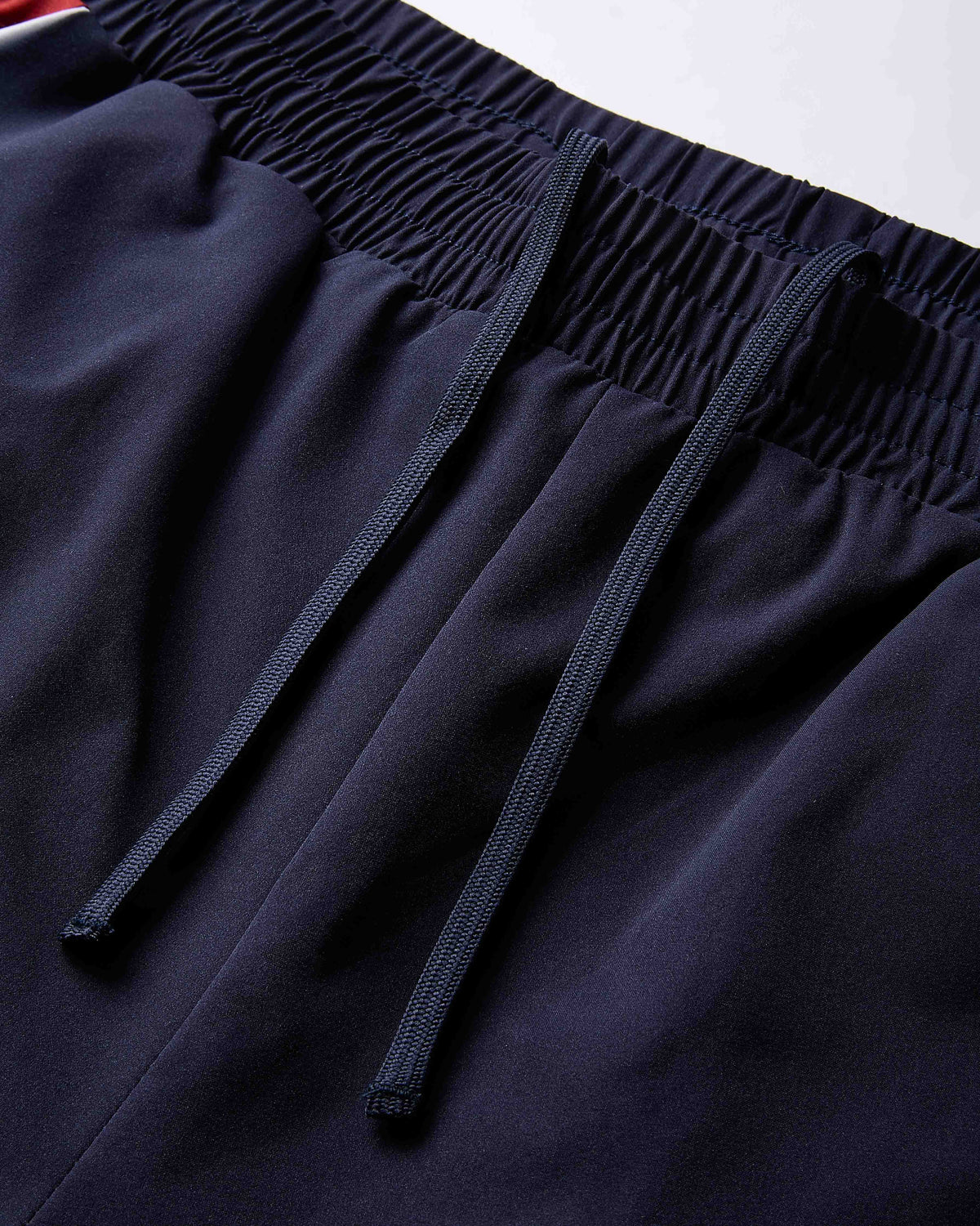Close-up of dark blue pants with an elastic waistband on a white background