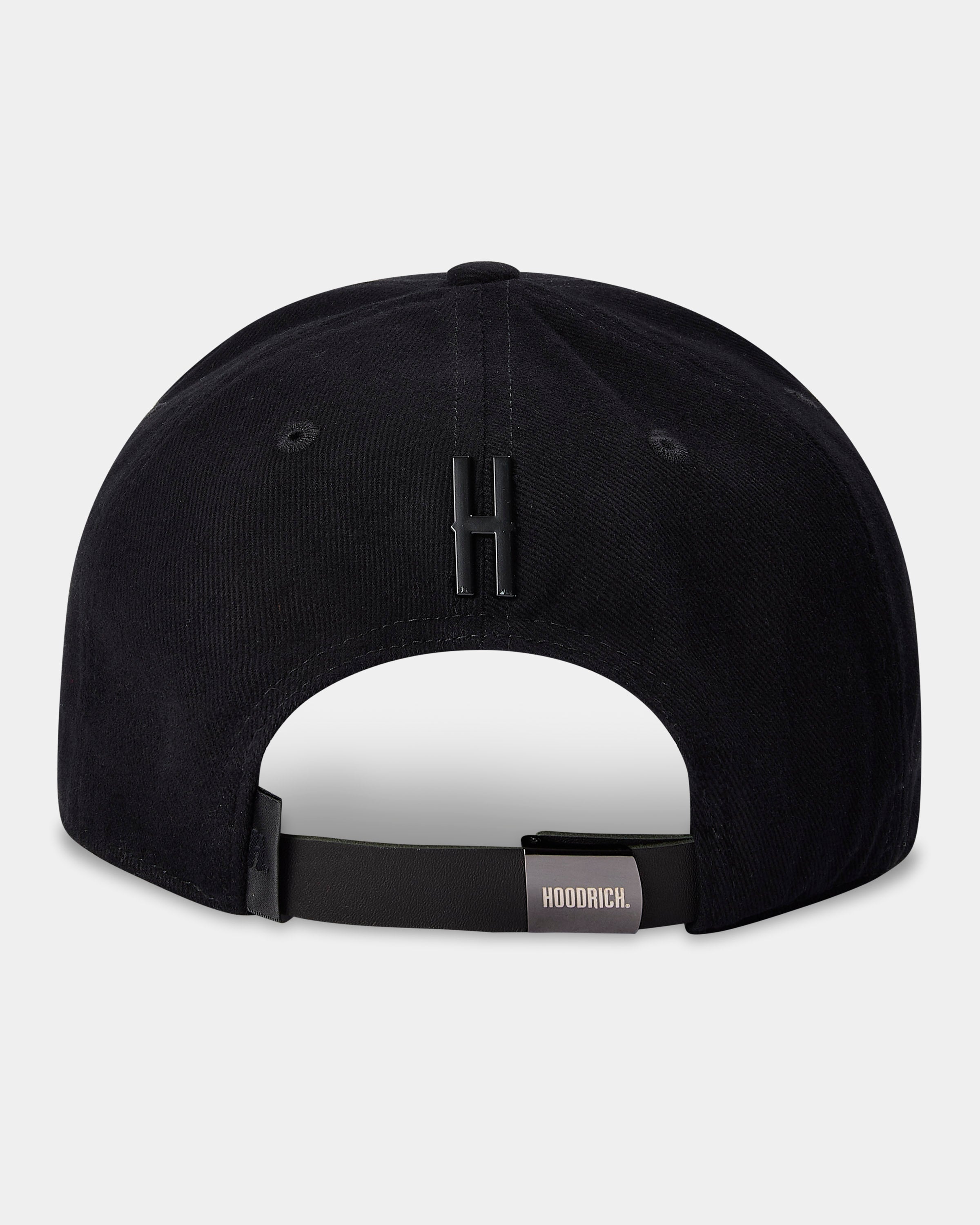 Black cap with a white patch and brand logo on a light gray background