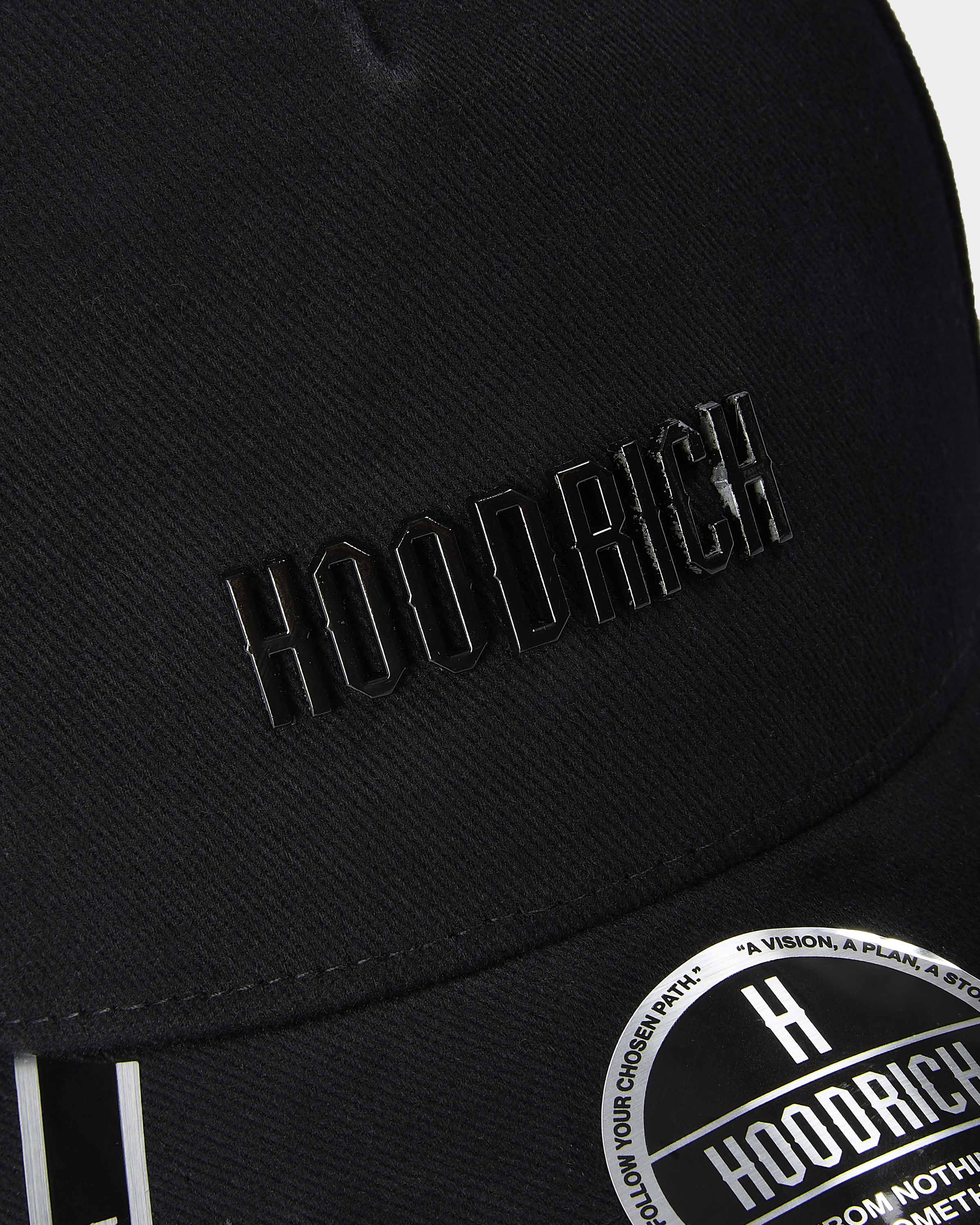 Black cap with 'Hoodrich' branding on a dark background