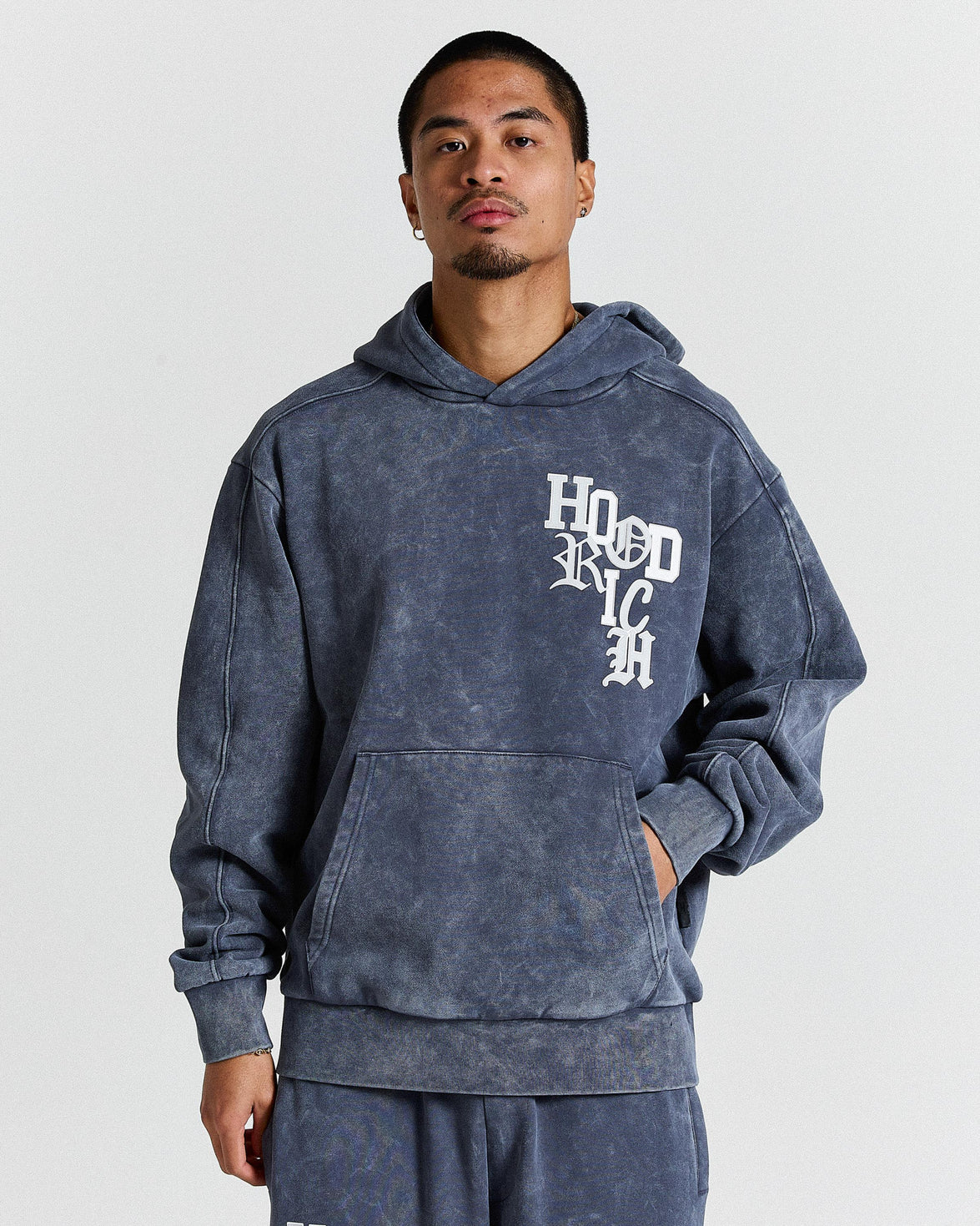 Person wearing a blue hoodie with text on a plain background