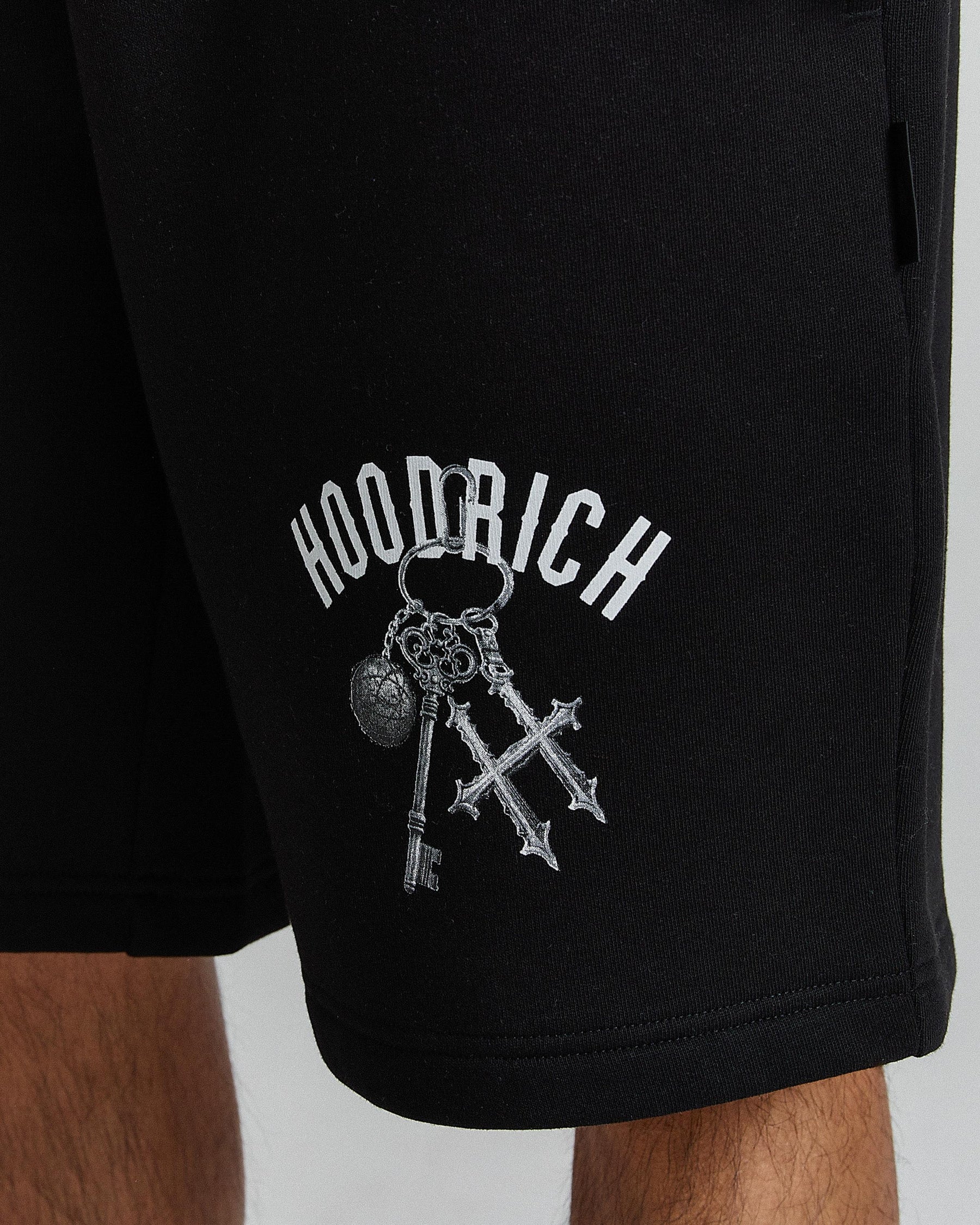 Black shorts with 'Hoodrich' logo featuring keys on a plain background