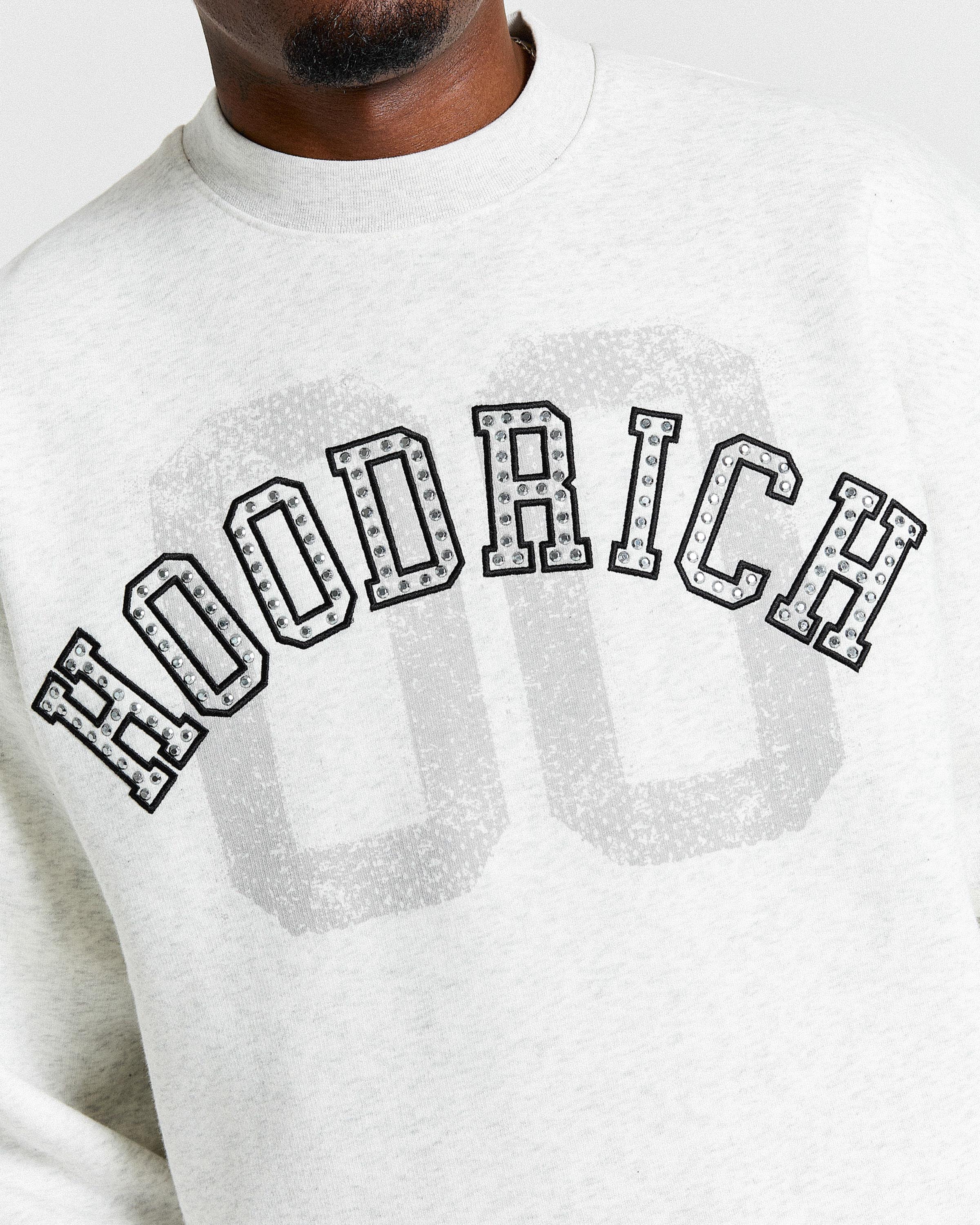 Displays a model wearing the Grey & Black 'Hoodrich' branded men's Rivet Full Tracksuit 
