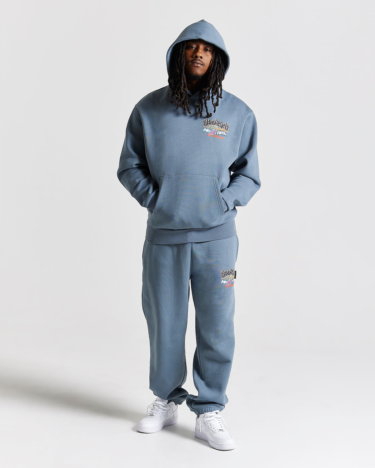 Displays a model wearing the Grey 'Hoodrich' branded men's Graff Rave Full Tracksuit