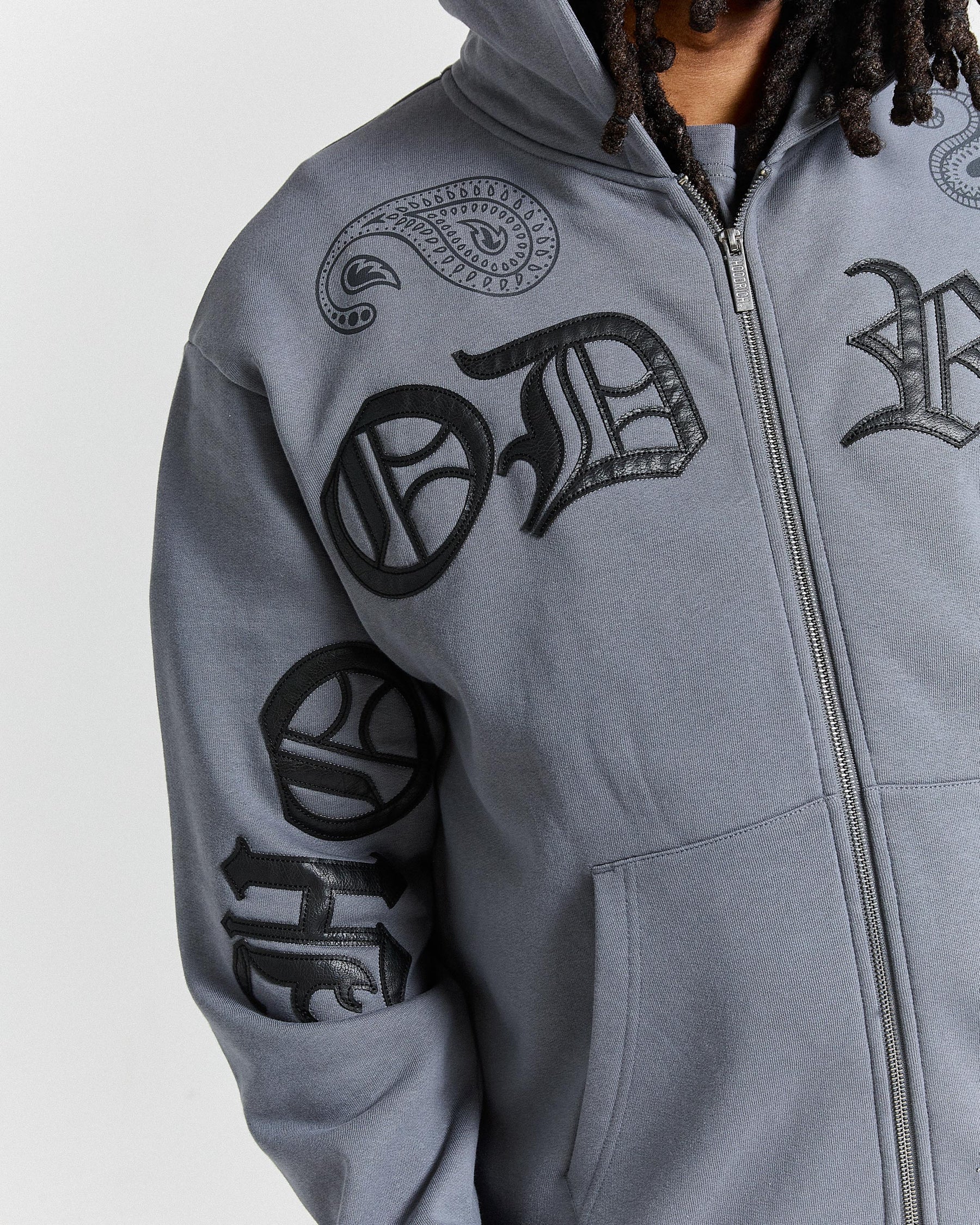 Gray hoodie with black tribal designs on a white background