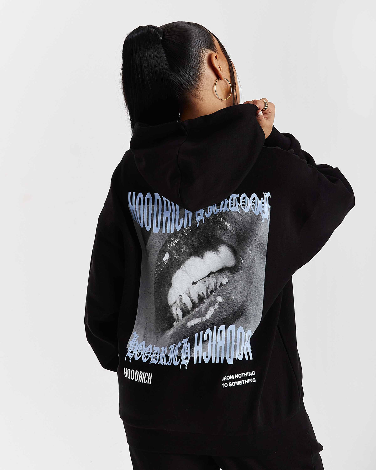 Displays a model wearing the Black 'Hoodrich' branded women's Flex Full Tracksuit 